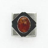 Amber in Metal